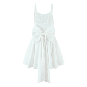 Detailed back view of a white sundress featuring a large decorative bow and thin straps
