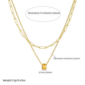 Double-layered gold-plated paperclip chain necklace with a textured round pendant charm