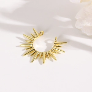 Exquisite gold sunburst necklace connector charm with radiant spikes on white background