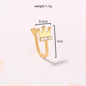 Macro shot of 1cm golden crown fake nose ring with three white cubic zirconia stones