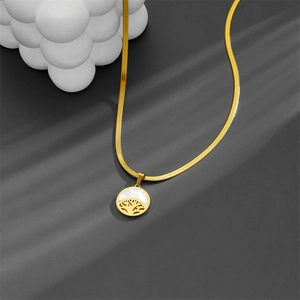 Golden snake chain necklace with white shell pendant and hollow life tree design detail