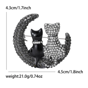 Elegant cat on crescent moon brooch with sparkling silver rhinestones and black finish