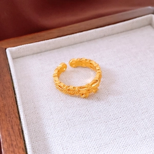 Detailed shot of vintage 24K gold plated hollow floral pattern ring in jewelry box