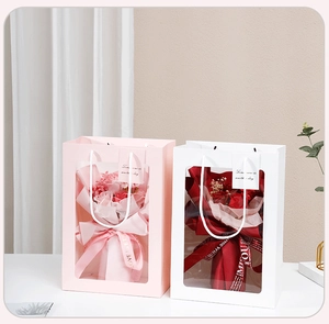 Detail of pink and white gift bags with transparent PVC windows for flower bouquets