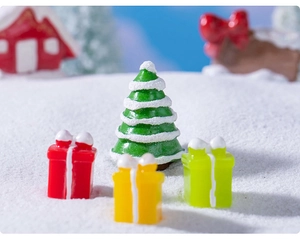 Gros plan d'un sapin de Noël miniature enneigé et coffrets cadeaux pour décors de fêtes