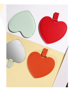 Detailed view of colorful heart-shaped PU leather mirror charms and luggage tags