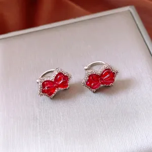 Luxury sparkling bow earrings with red stones and zircon pavé on silver metal base