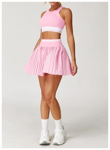 Detail of pink pleated tennis skirt with white waist stripe and stretch fabric texture