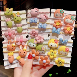 Detailed view of colorful cartoon hair ties set featuring rabbits and cute fruit charms