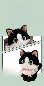 Close-up of black and white plush cat toy featuring green eyes and a pink lace bow