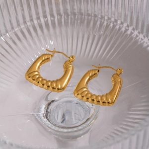 Gros plan détaillé de créoles épaisses en U plaquées or 18 carats texturées en verre