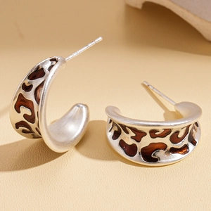 Close-up of S925 sterling silver studs with C-shaped brown leopard print pattern
