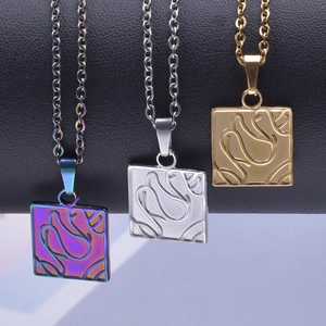 Square abstract line pendants in gold, silver, and purple finishes on a sleek dark bar