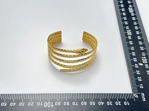 Detailed view of gold snake-scale textured wrap bracelet with precision measurements