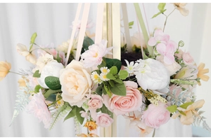 Detail of floral hanging wreath with pink roses, white peonies and silk ribbons