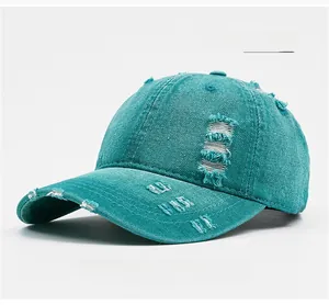 Detailed side view of distressed grass green denim baseball cap with frayed hole texture