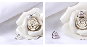 Detailed view of S925 silver triangle stud earrings with white and lavender pearls