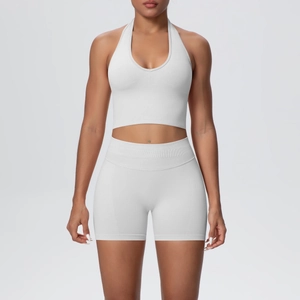 Detailed view of white seamless knitted yoga set with halter top and high-waisted shorts