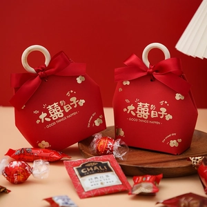 Chinese wedding candy box with wooden handle and red ribbon on red festive background