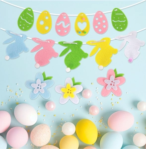 Flat lay of colorful felt Easter egg and bunny banner garlands on light blue background