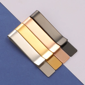 Detail view of four-color polished stainless steel tie clips in silver gold and black