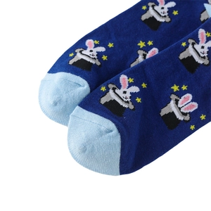 Close-up of navy blue cotton sock featuring a magician rabbit and top hat embroidery