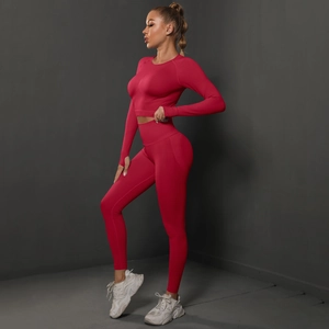 Detail of seamless magenta gym set featuring thumb-hole cuffs and ribbed high-waist band