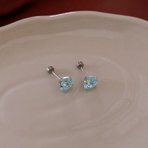 Detail showing blue zircon stud earrings with secure screw-back design and silver base