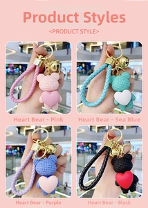 Details of resin heart bear keychains in pink, blue, purple, and black with gold bells
