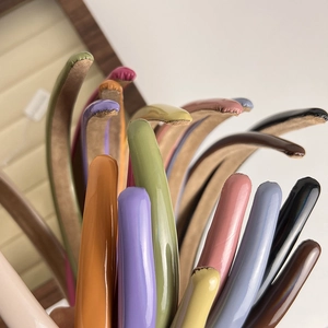 Detailed macro view showing diverse vibrant colors and glossy finish of the slim headbands