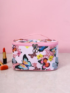 Detail of floral butterfly print on pink square makeup bag with gold zipper and top handle