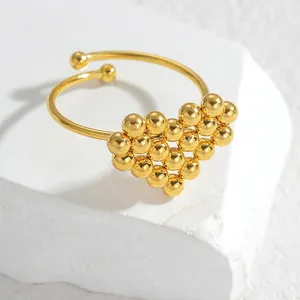 Minimalist 18K gold plated stainless steel open heart ring on white stone base