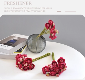 Detailed view of dark red artificial roses in a glass vase for home wedding decoration