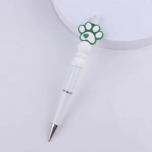 Detail of creative DIY beaded pen with white barrel and green silicone cat paw top