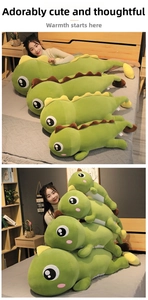 Long green dinosaur plush pillow in four sizes showing soft fabric and cute facial details