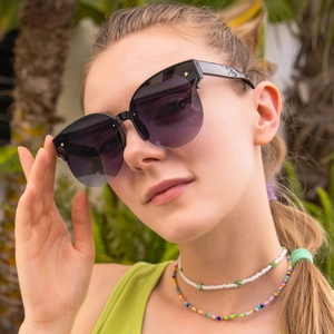 Retro cat-eye semi-rimless sunglasses with black gradient lenses and rivet details