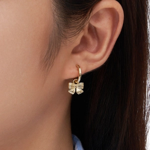 Minimalist S925 silver hoop earrings with gold bow charm shown on model in close-up