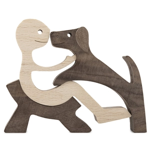 Detailed view of handmade wooden sculpture showing a man interacting with his dog