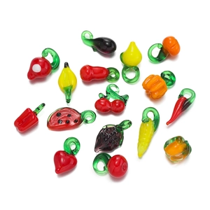 Detailed macro view of vibrant glass fruit pendants including watermelon and strawberry