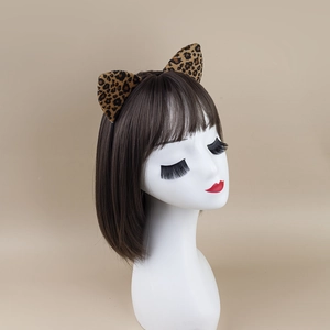 Leopard print plush cat ear headband on a white head mannequin for Halloween party costume