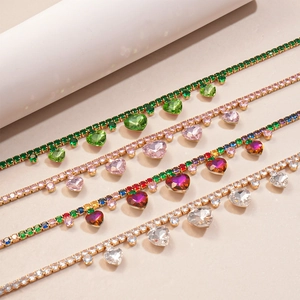 Detail of rhinestone heart pendants on chains in green, pink, multicolor, and silver