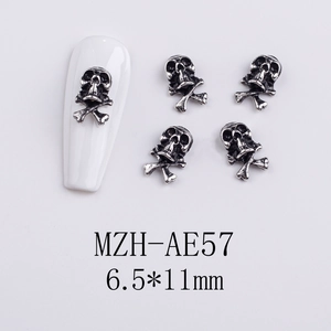 Macro detail of silver skull and crossbones nail charms with model MZH-AE57 on fake nails