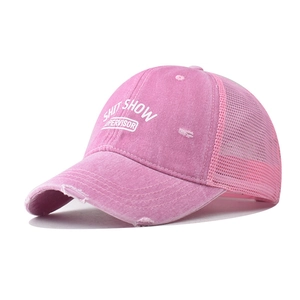 Detail of pink distressed trucker hat with white Shit Show Supervisor embroidery