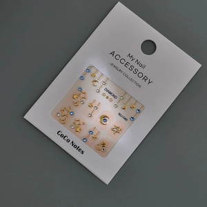 Star and moon embossed nail art stickers with blue rhinestones and gold charms