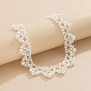 Detailed view of woven pearl choker featuring white layered beads and lace-like texture