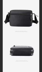 Detail view of the black nylon shoulder bag showing a smooth base and metal zipper