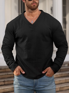 Detail of black V-neck men's knit sweater featuring premium textured cable knit pattern