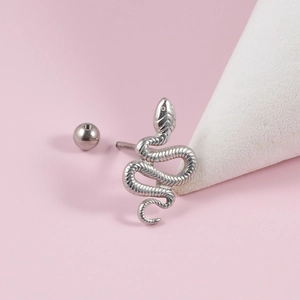 Macro shot of a silver punk snake tongue ring with polished finish and spherical end