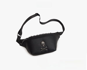 Close-up of black leather waist bag with silver rhinestone skull emblem and metal zipper