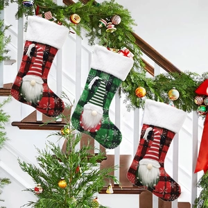 Three Christmas stockings with 3D gnomes and faux fur trim hanging on festive staircase